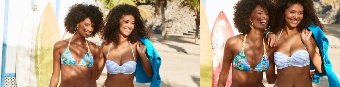 Twee vrouwen in bikini op het strand met surfplanken op de achtergrond
